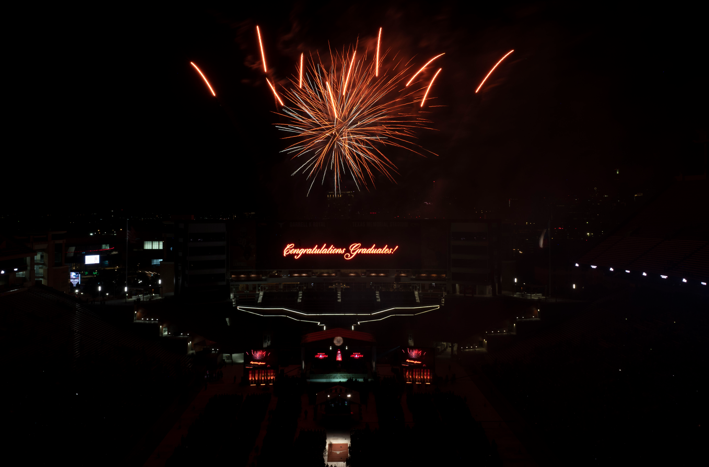 Fireworks appear over the words "Congratulations, graduates!" and a Longhorn silhouette.